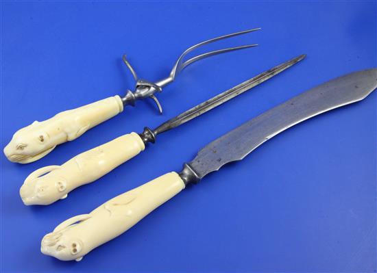 An early 20th century three piece walrus tooth handled steel carving set, knife 15.25in.